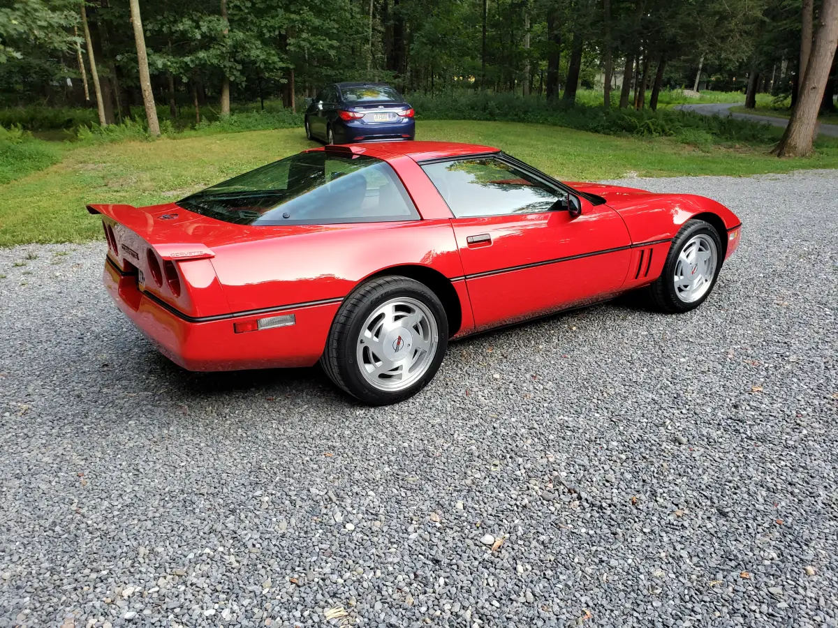 Red C4 Corvette rear three-quarter view showing a deep glossy ceramic coated finish