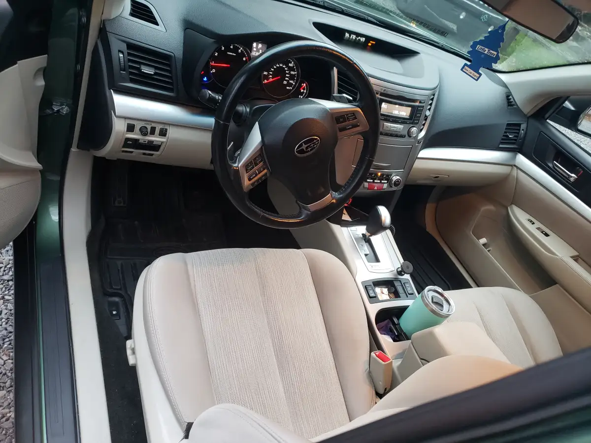 Subaru dashboard and steering wheel view after interior detailing with air freshener