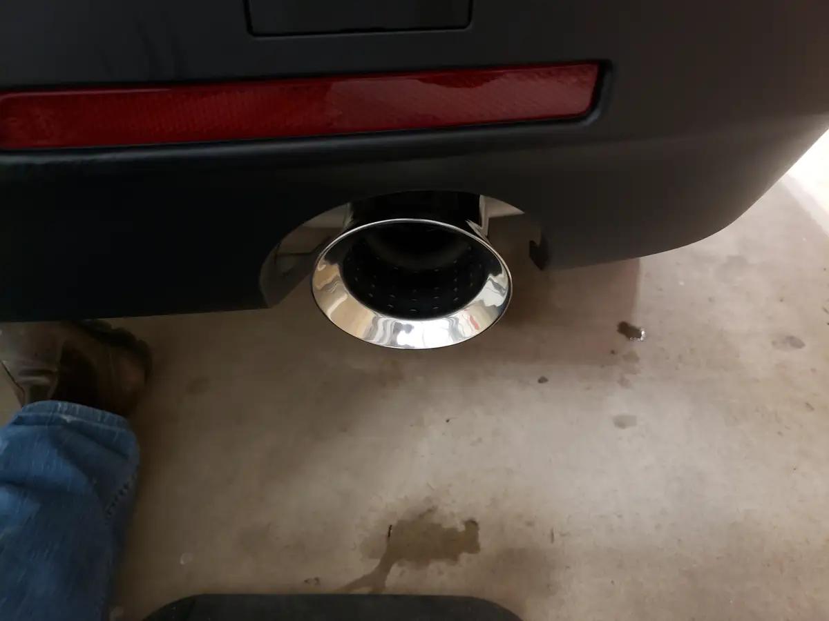 Close-up of a polished chrome exhaust tip on a detailed vehicle