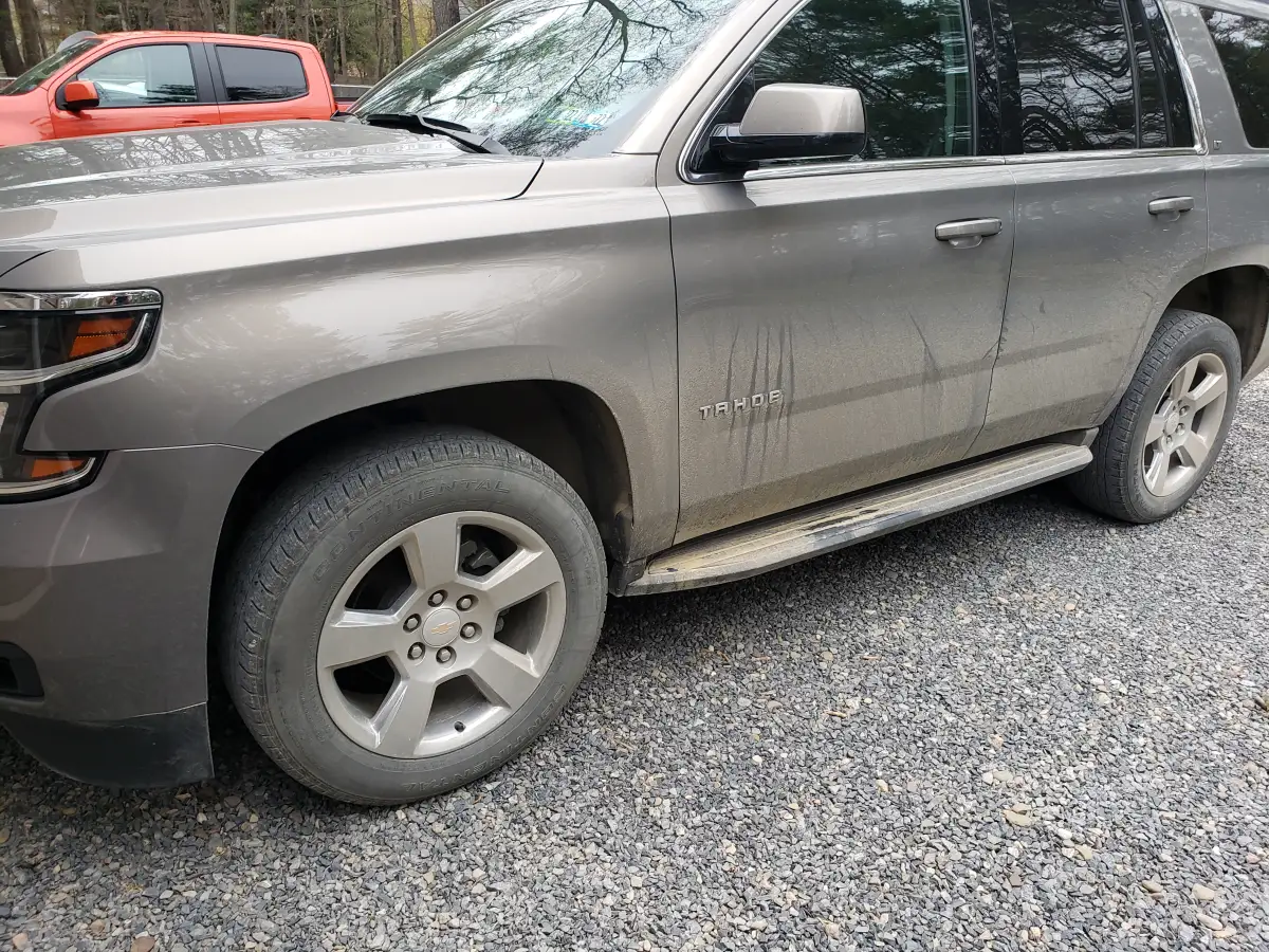 Dust-streaked gray Chevrolet Tahoe side panel awaiting exterior detailing