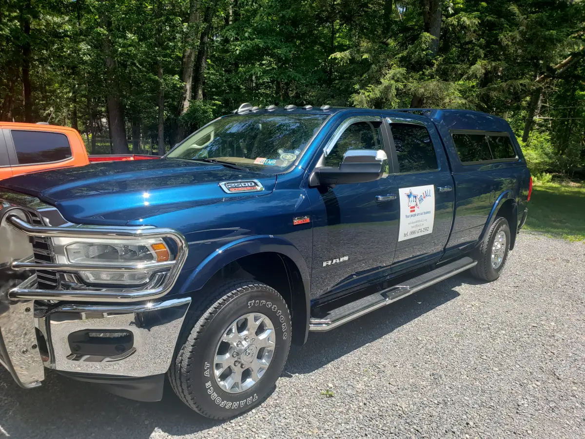 Detailed dark blue Ram 2500 pickup truck with a bed cap parked outdoors