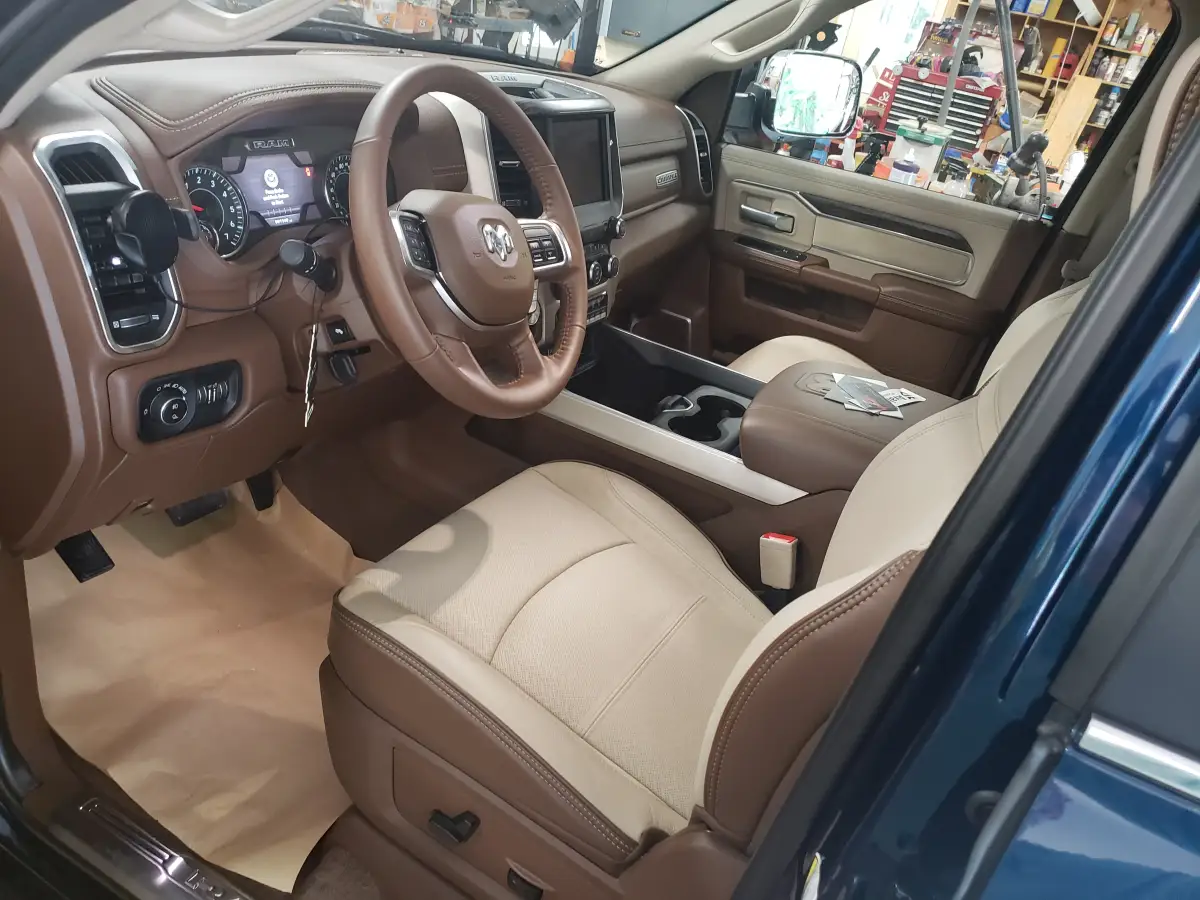 Clean brown and tan leather interior and dashboard of a Ram pickup truck
