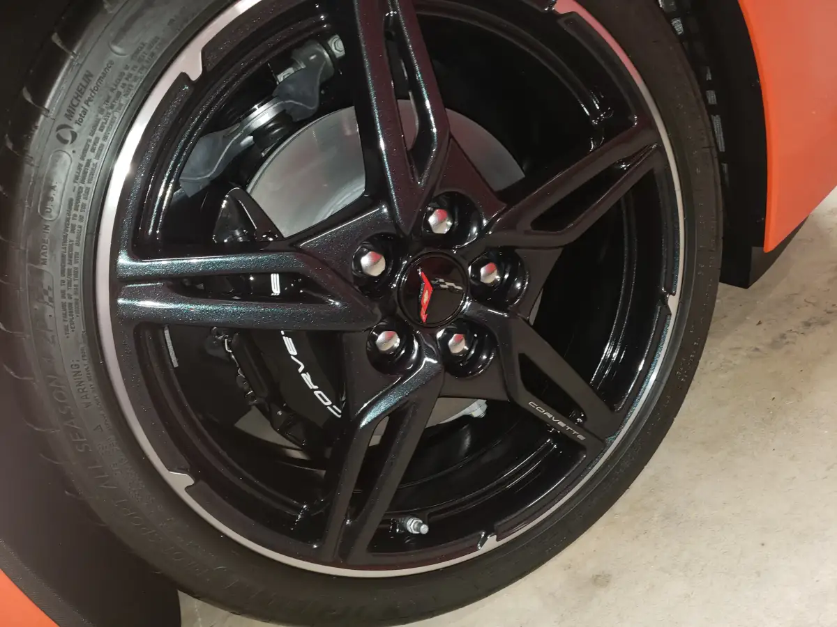 Close-up of a black Corvette wheel and caliper after detailing
