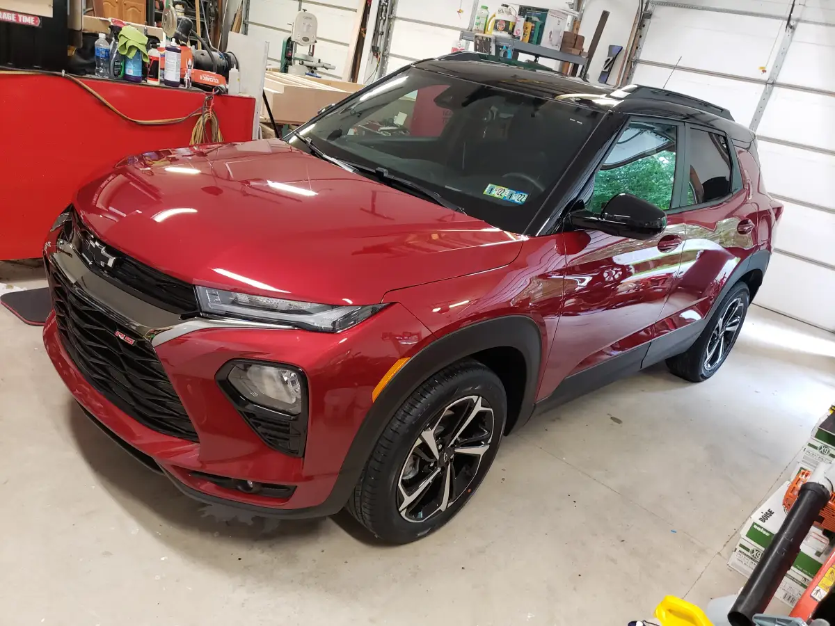 Freshly detailed red Chevrolet Trailblazer RS SUV parked in a garage
