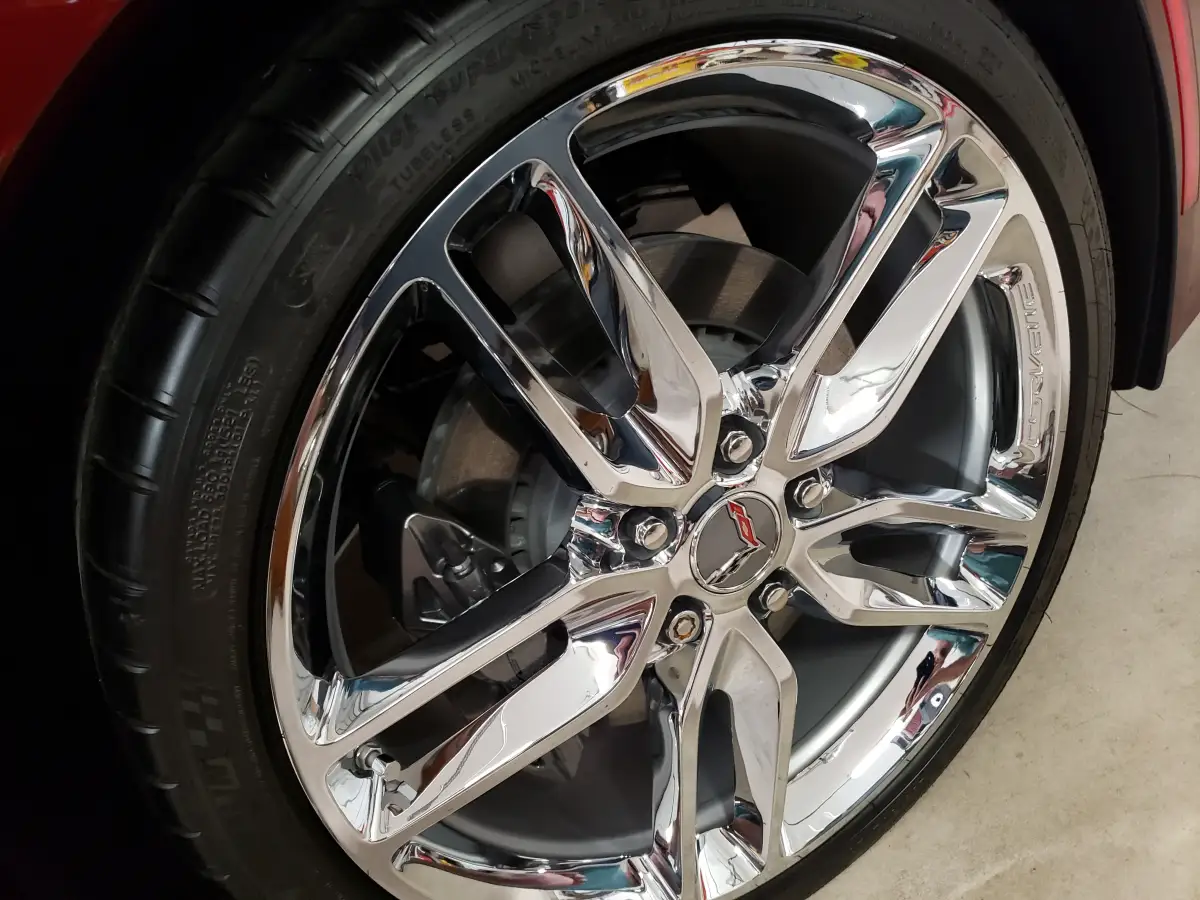 Close-up of a polished chrome Corvette wheel after detailing