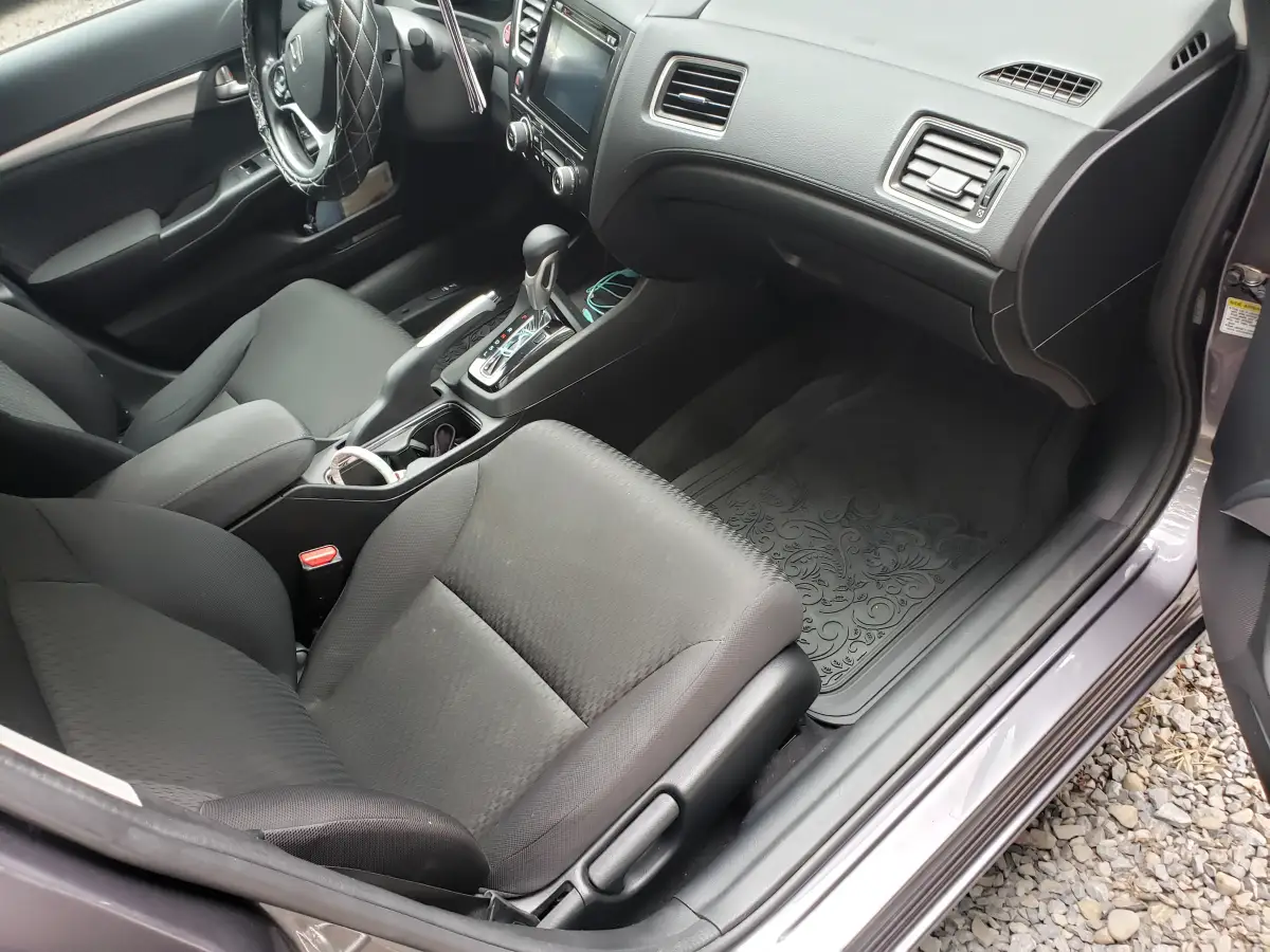 Clean gray cloth front seats and center console of a Honda Civic after interior detailing
