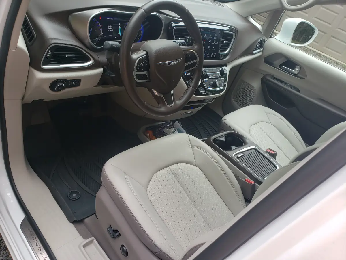 Beige leather dashboard and steering wheel of a Chrysler Pacifica minivan after interior cleaning