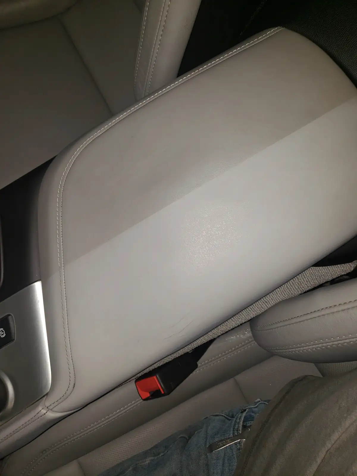 Clean gray leather car console and seat edge after interior detailing